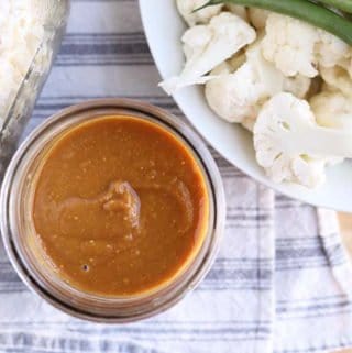 easy peanut sauce in jar with rice and cauliflower