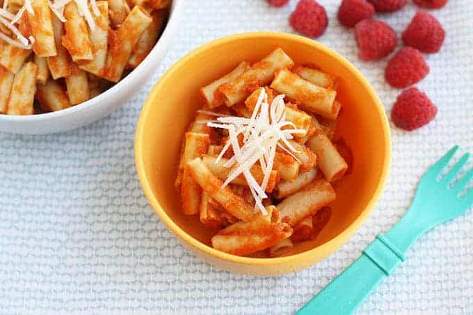 easy marinara sauce with pasta and cheese in yellow bowl with raspberries