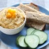 butternut squash hummus on plate with cucumbers