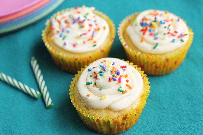 healthy vanilla cupcakes with sprinkles on teal towel