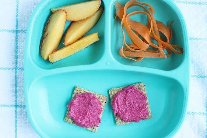 beet hummus on crackers on divided plate