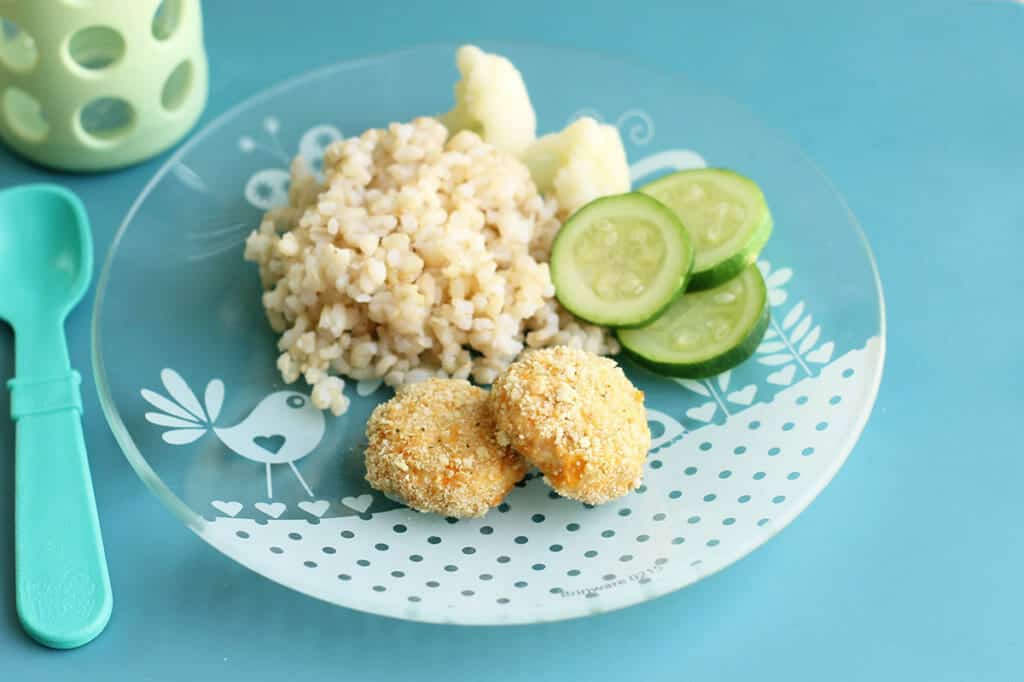 homemade chicken nuggets on plate with rice and zucchini