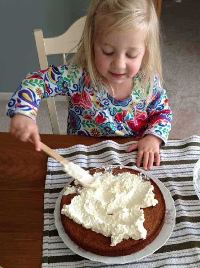 girl frosting healthy chocolate chip banana cake