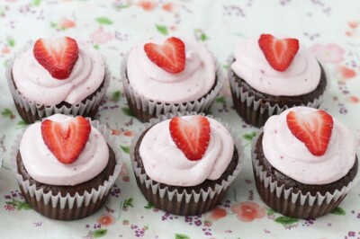 chocolate cupcakes in a row with strawberries