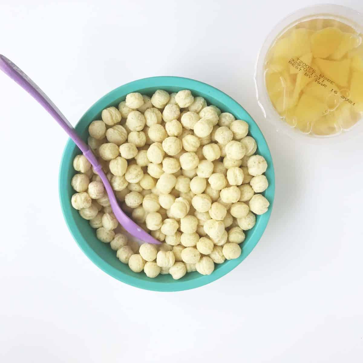 kix in teal kids bowl with canned fruit