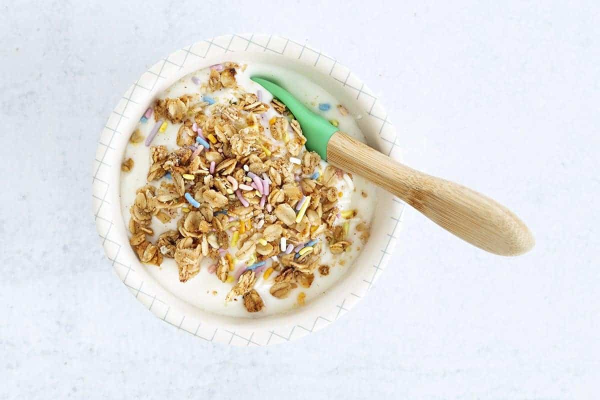 nut-free granola on yogurt in bowl.
