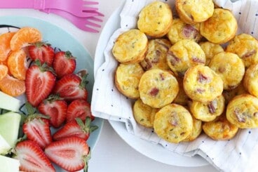 bacon egg and cheese cups in bowl with strawberries