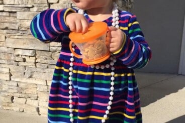 toddler with snack cup