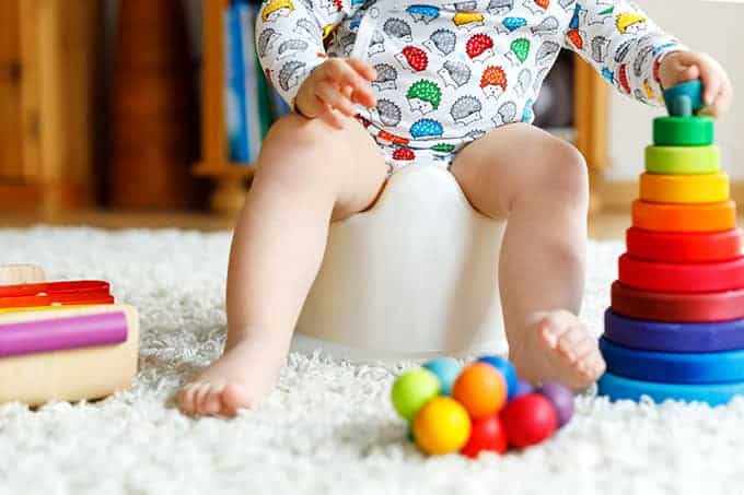 toddler-on-potty-chair-with-toys