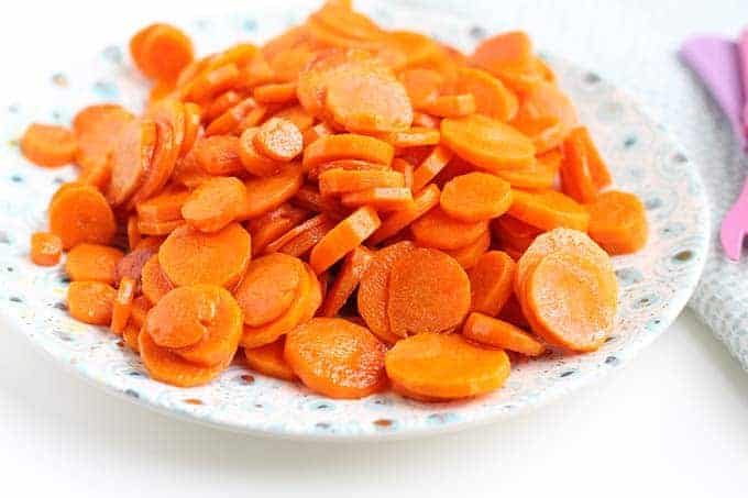 sliced sauteed carrots with butter on a plate