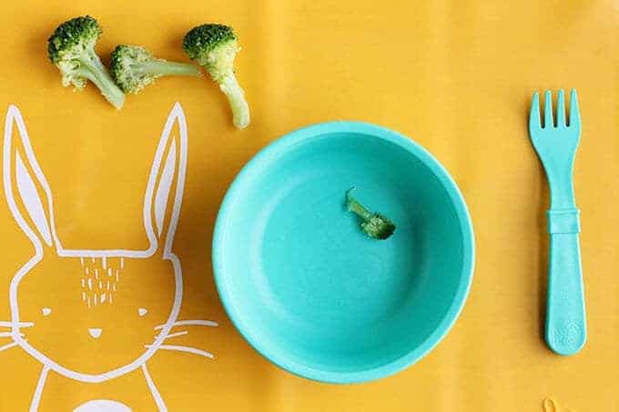 picky eating toddler plate on yellow placemat with fork and broccoli