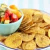 fruit salsa in blue bowl with plantain chips on plate