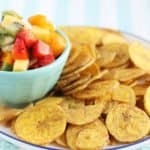 fruit salsa in blue bowl with plantain chips on plate
