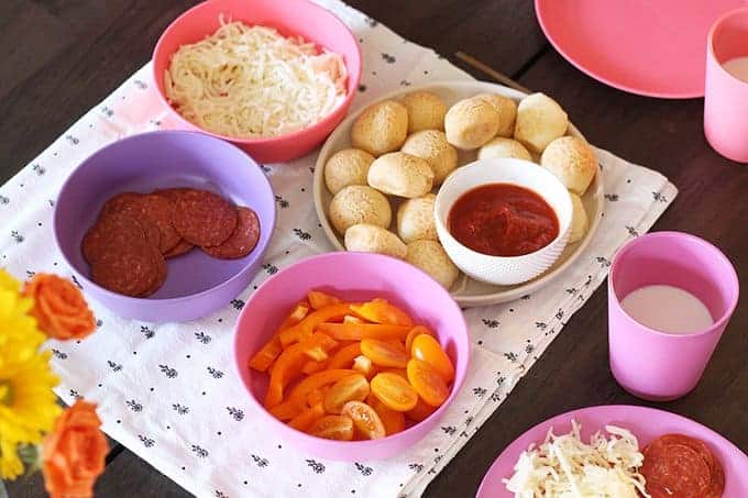 kids pizza party with toppings in pink bowls