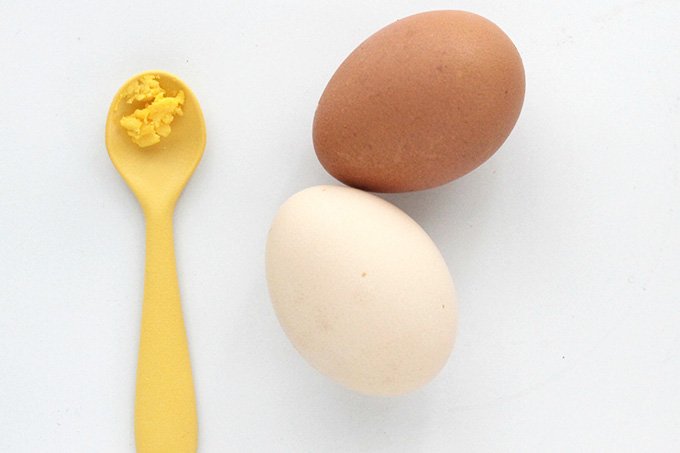 hard cooked eggs and yellow baby spoon