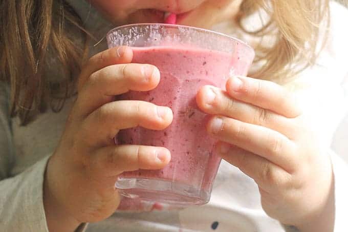toddler drinking cherry smoothie