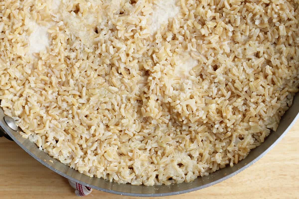 fully cooked rice in pot with chicken.