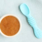 peach puree for baby in white bowl