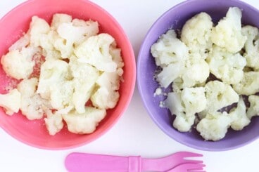 steamed-caulifower-with-cheese-in-pink-and-purple-bowl