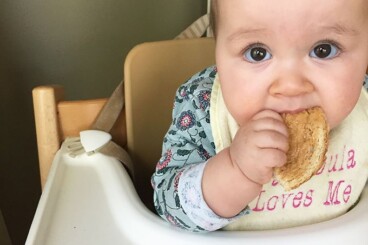 baby eating peanut butter toast