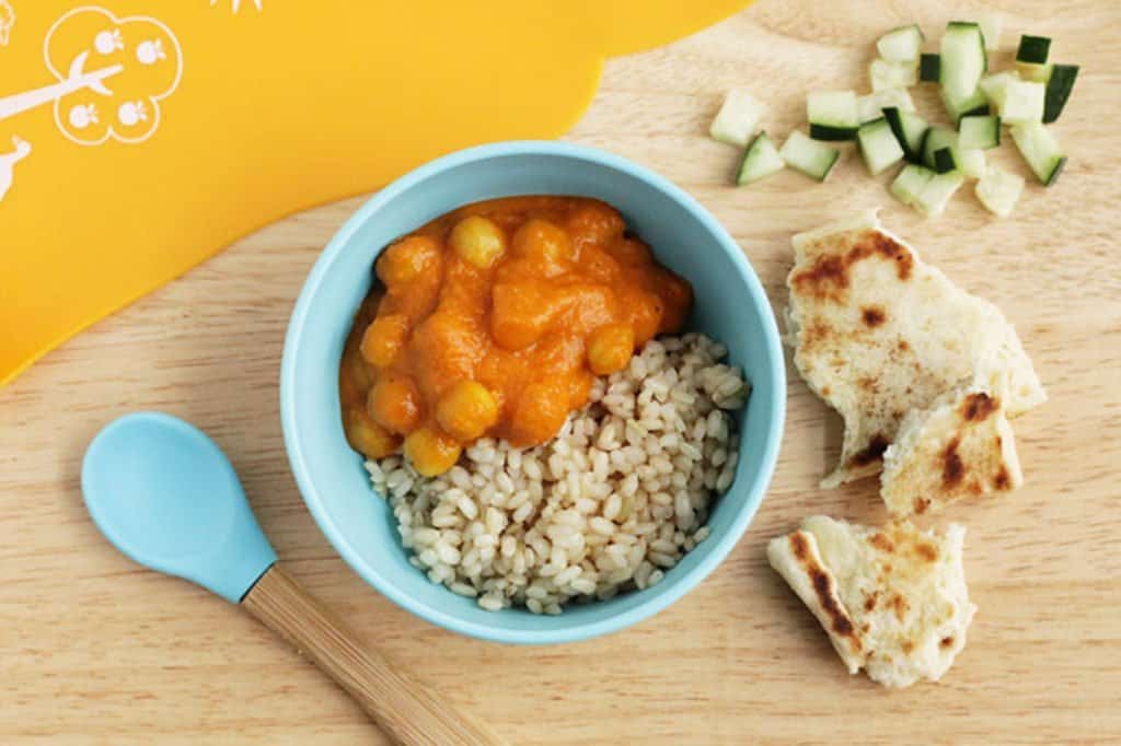 chana masala with rice in kids bowl with cucumbers and bread