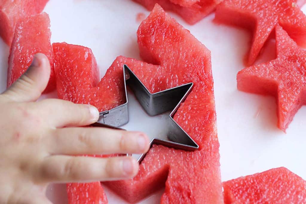 kids-hand-cutting-watermelon