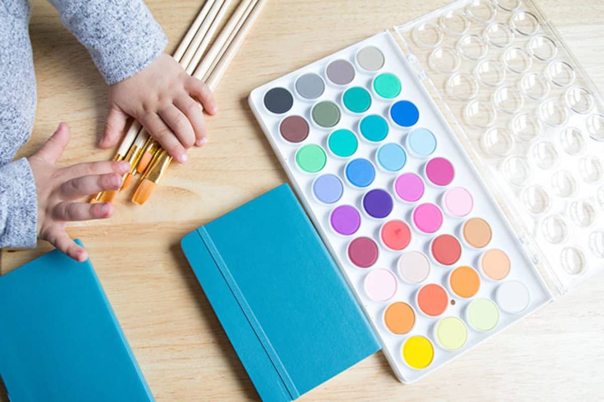 watercolors with toddler hand