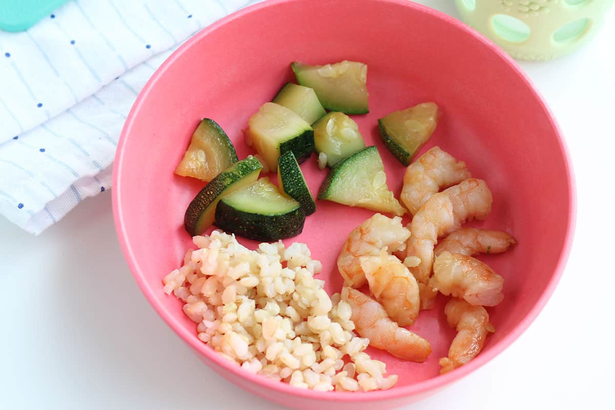 teriyaki shrimp stir fry in pink bowl.