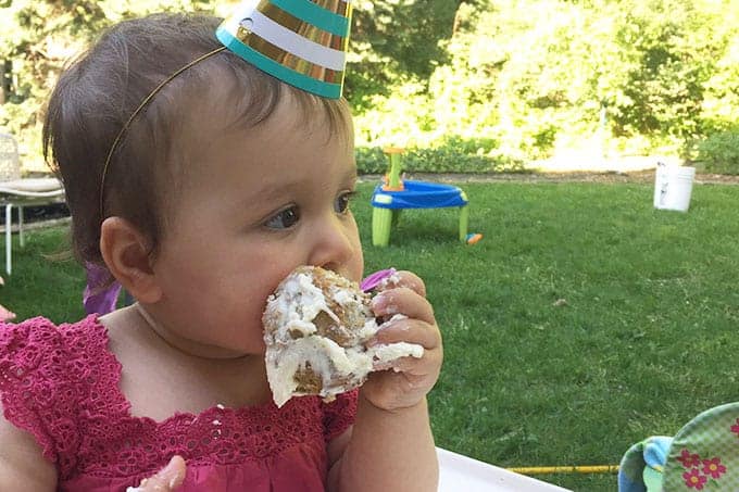 toddler-eating-first-birthday-cupcake