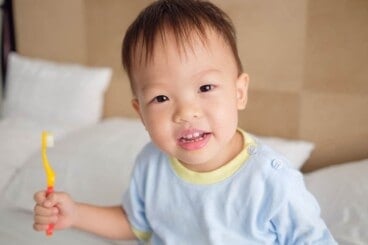 toddler-with-yellow-toothbrush