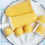 mango popsicles on white plate