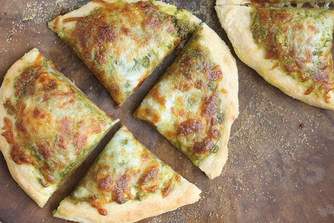 pesto-pizza-sliced-on-baking-stone