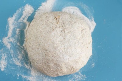 ball-of-whole-wheat-pizza-dough-on-blue