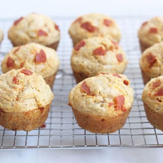 pizza-muffins-on-wire-rack-with-kids-hand
