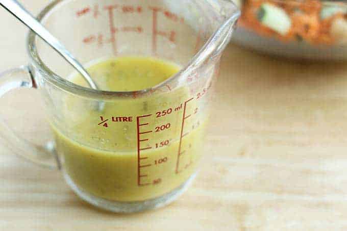 quinoa salad dressing in measuring cup
