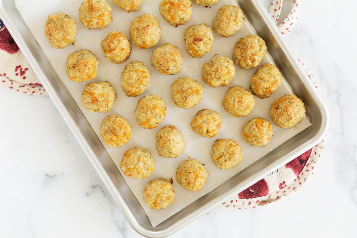 baked chicken meatballs on cookie sheet. 