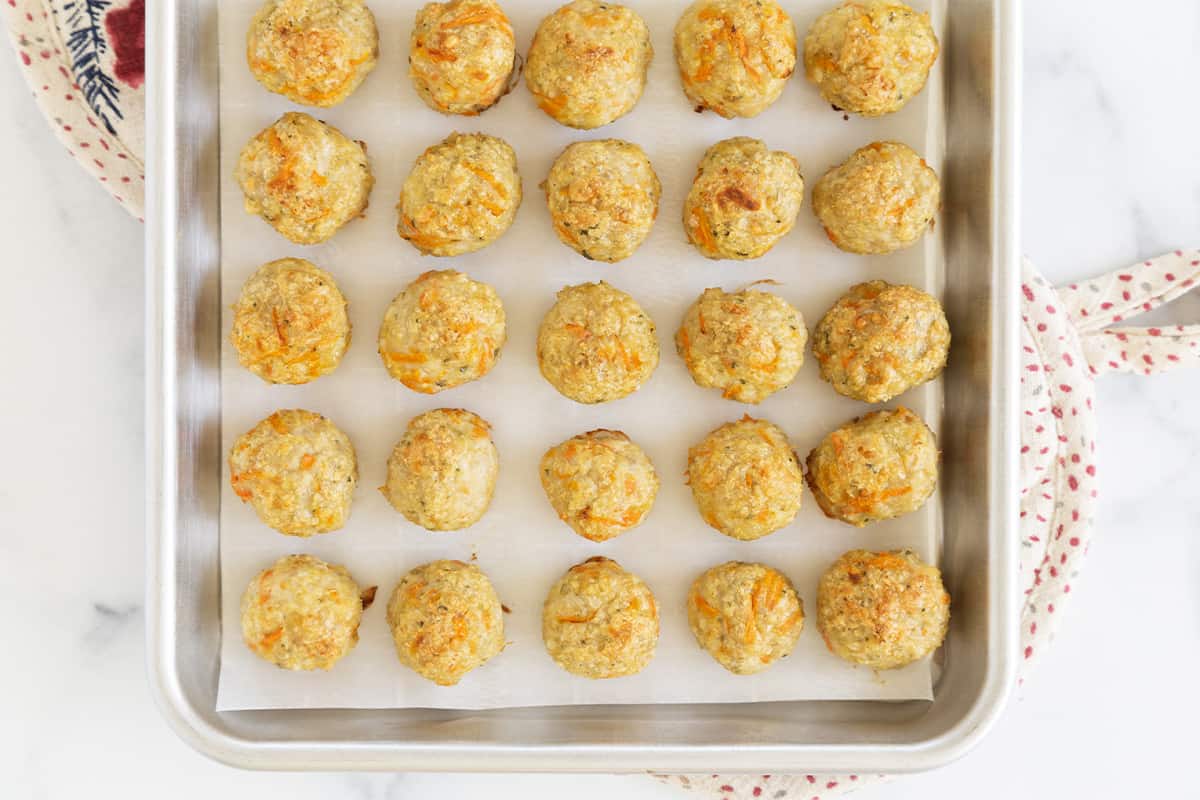 baked chicken meatballs on cookie sheet.