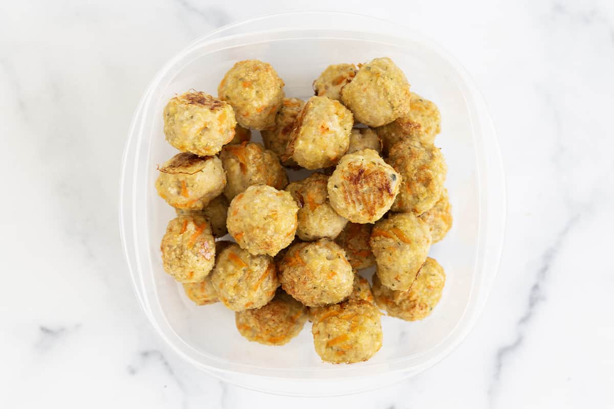 baked chicken meatballs in storage container.