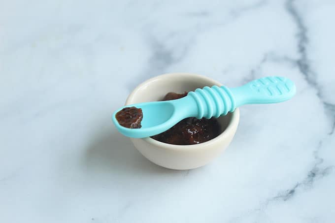 prune-puree-in-white-bowl-with-spoon