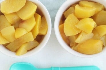 stewed peaches in two white bowls
