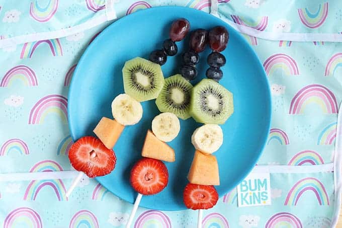 rainbow-fruit-sticks-on-blue-plate