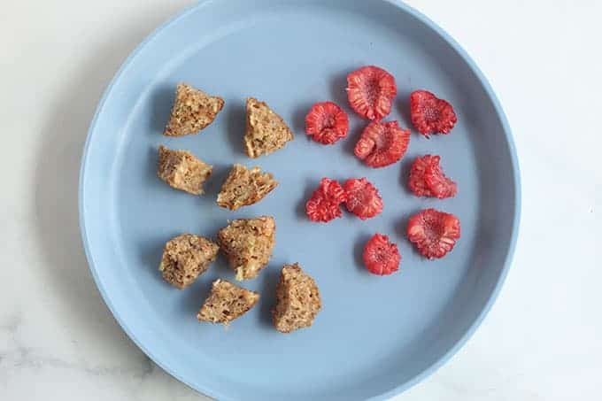 baby-mufifn-and-raspberries-on-blue-plate