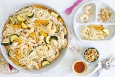 Pan with shrimp and noddles and kids plate on side