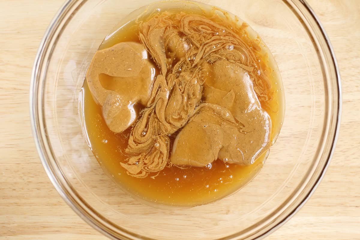 Peanut butter and honey in a glass bowl.