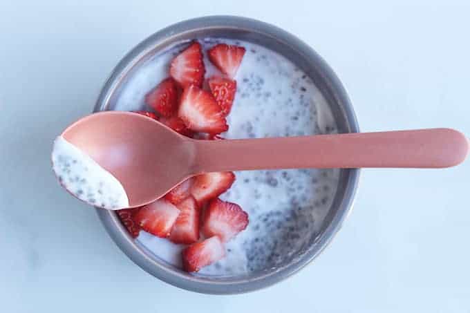 spoon of coconut chia pudding over bowl