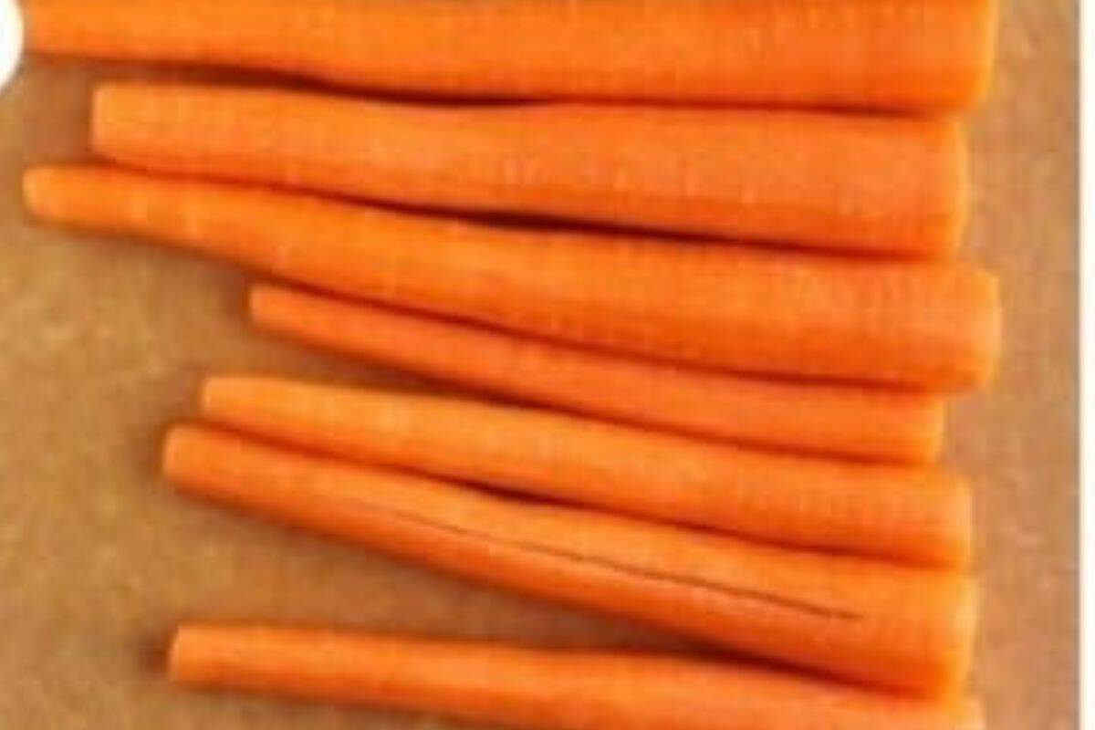 peeled carrots on cutting board for carrot fries.