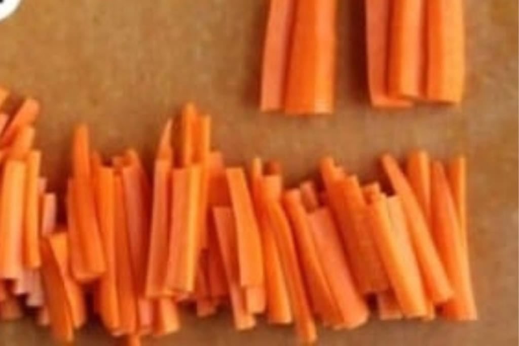 Carrot sticks on cutting board for carrot fries.