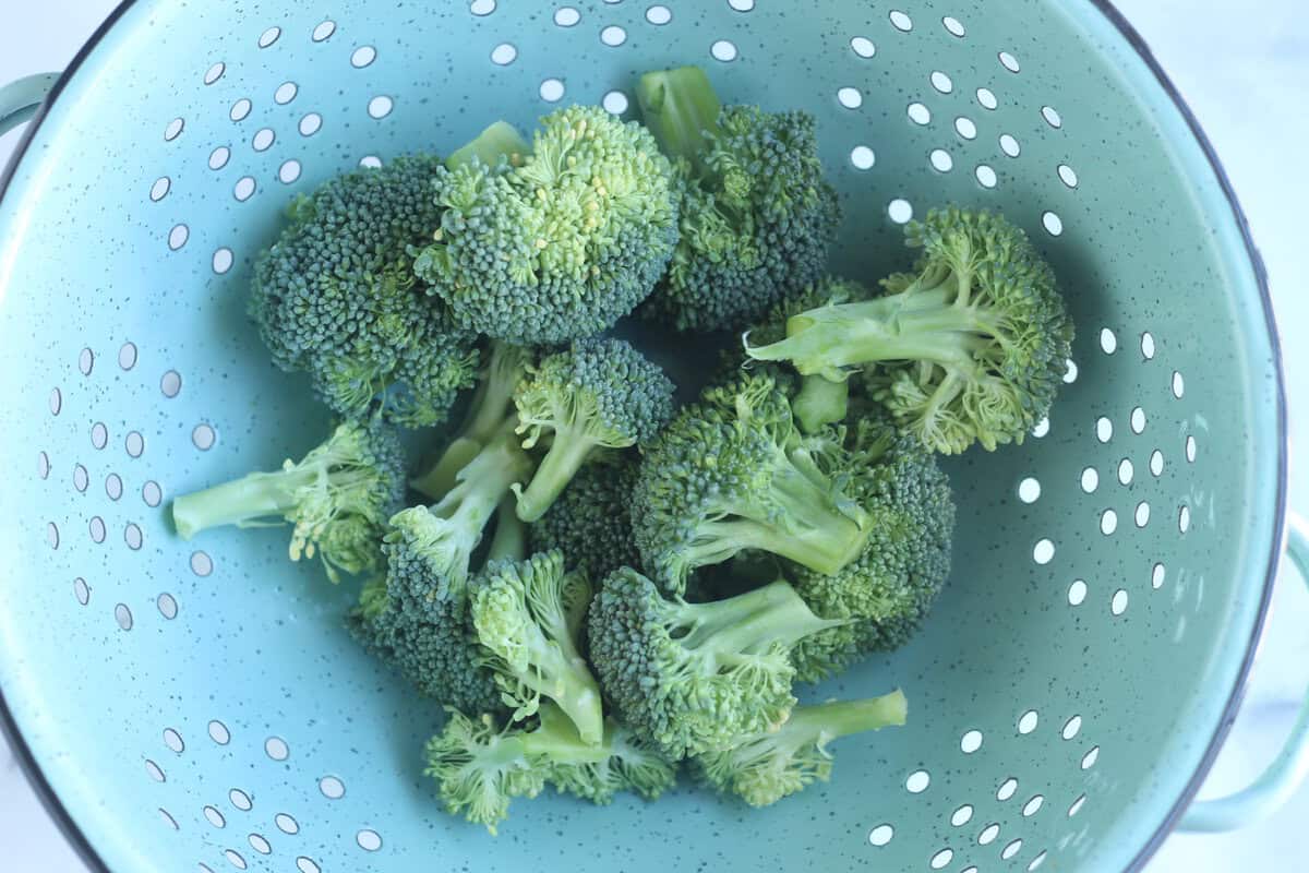 Broccoli in strainer to be washed.