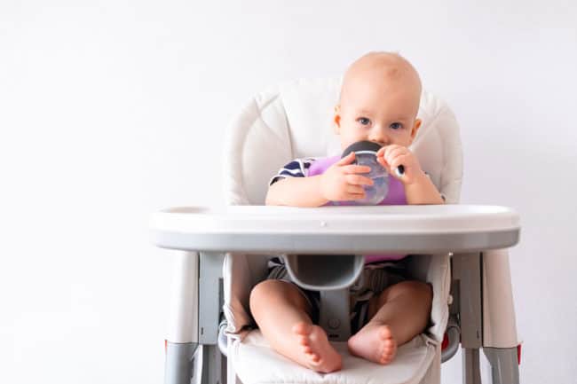 baby-drinking-water-in-highchair