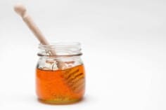 honey in jar on white background